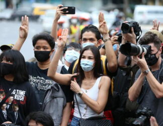 epa08582184 Thai student and pro-democracy activists flash the three-fingered salute for anti-government, as they take part on a Harry Potter themed pro-democracy protest against the government near the Democracy Monument in downtown Bangkok, Thailand, 03 August 2020. The pro-democracy activists gathered to protest the government and to call for change. EPA/NARONG SANGNAK